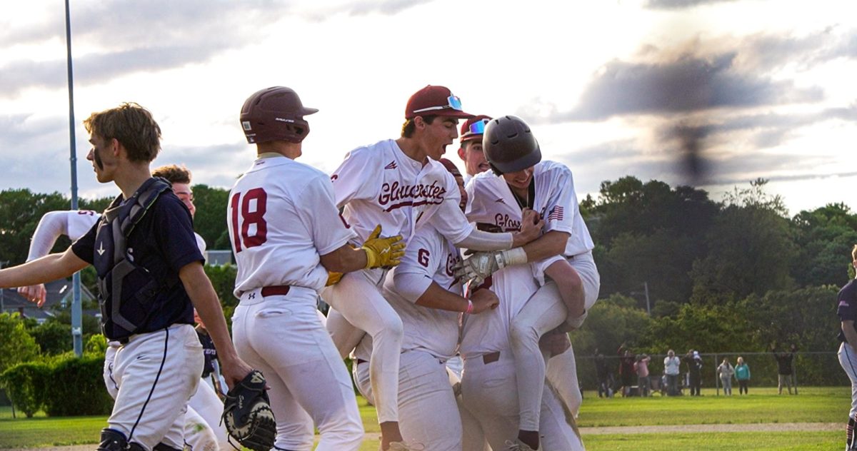 Brayden Francis lifts Nolan Aiello in celebration after scoring the winning run in the tenth inning.