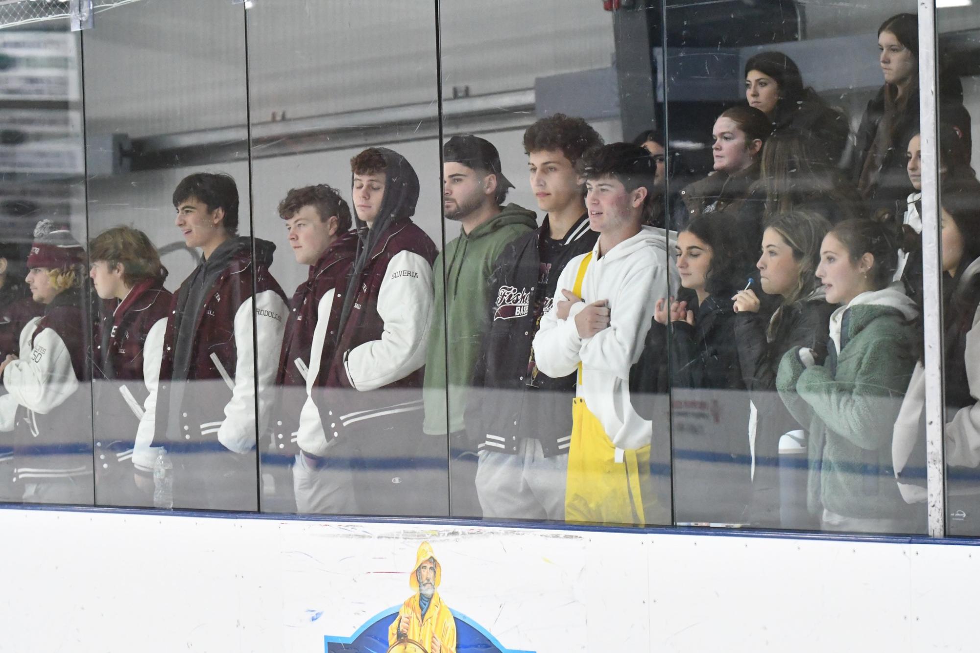Brayden Francis (center), donning a traditional Fishermen jumpsuit, puts his hand over his heart during the National Anthem.
Photo by Melissa Francis (approved for use)