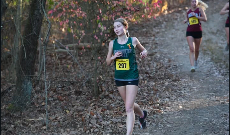 Grace Castellucci runs down a path during a race. [Courtesy photo by Manchester Essex Athletics]