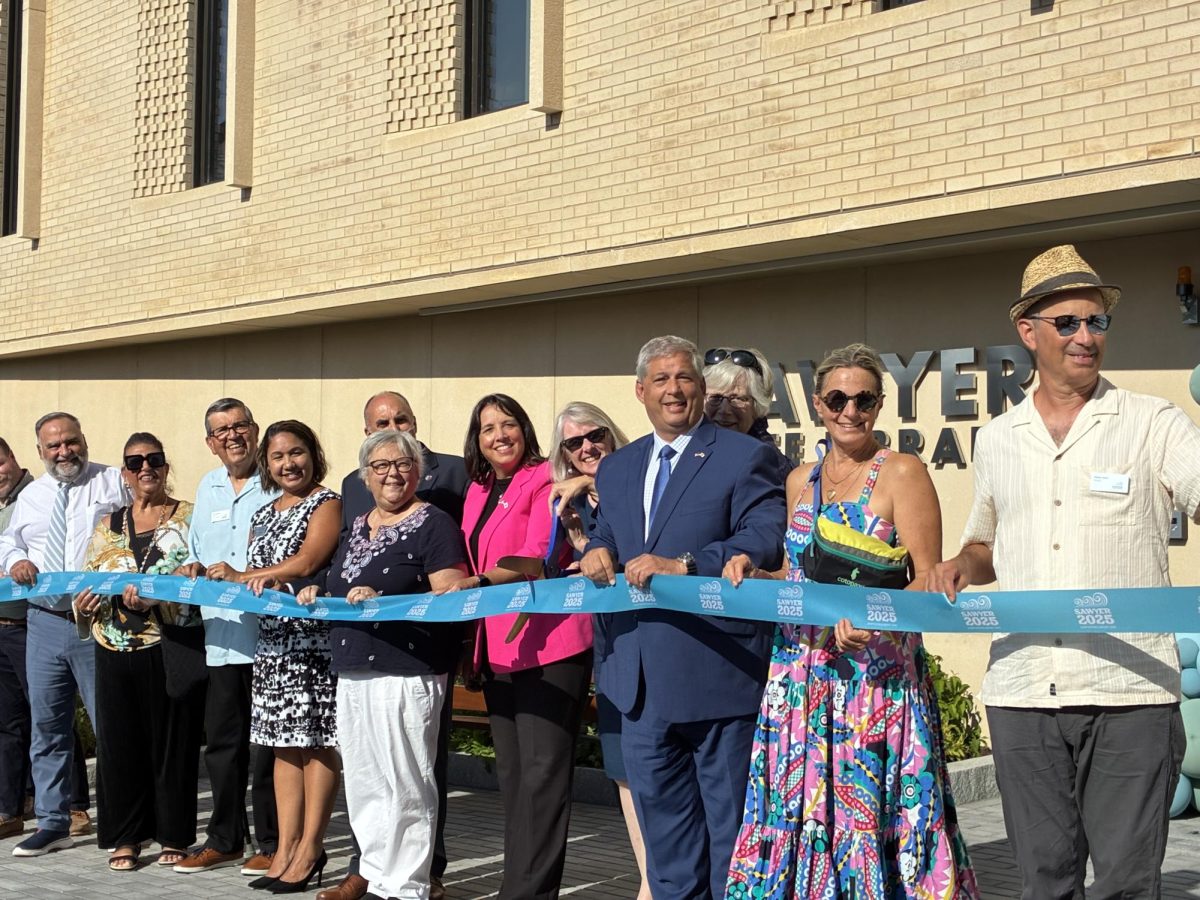 Mayor Greg Verga,  State Representative Ann Margerite Ferrante, Lt. Governnon Kim Driscoll, State Senator Bruce Tarr,  Sefatia Romeo Theken, Jenny Benedict,  and other officials gather at the ribbon cutting ceremony.