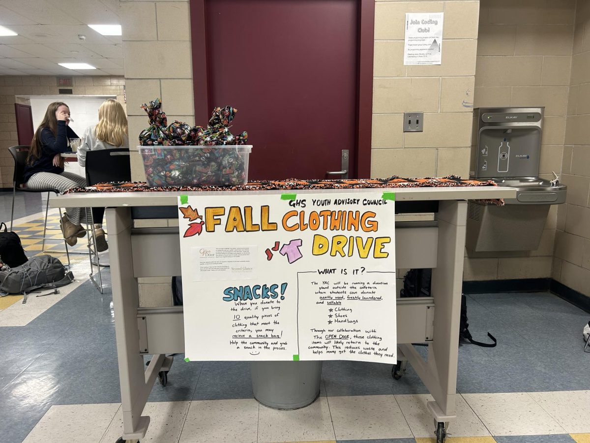 The Youth Advisory Council clothing drive stand outside of the Cafeteria