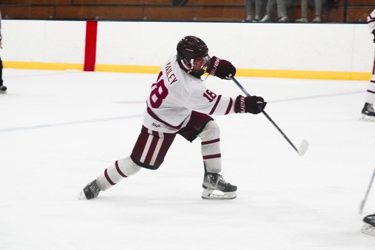 Chris Dailey shoots the puck past a Masconomet defender in a game last season. The Fishermen will retire his jersey this Saturday.