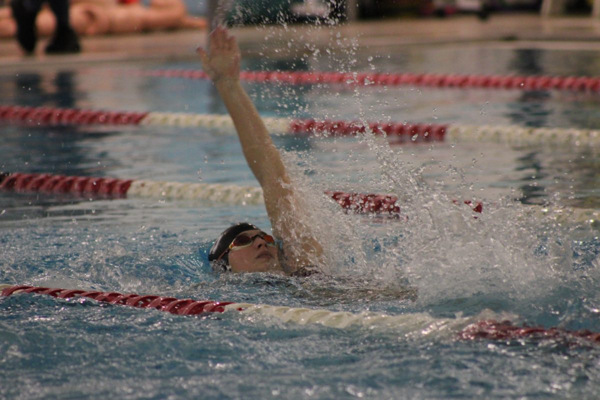 Sophomore Anna Patrick competes in the 100 meter backstroke. 