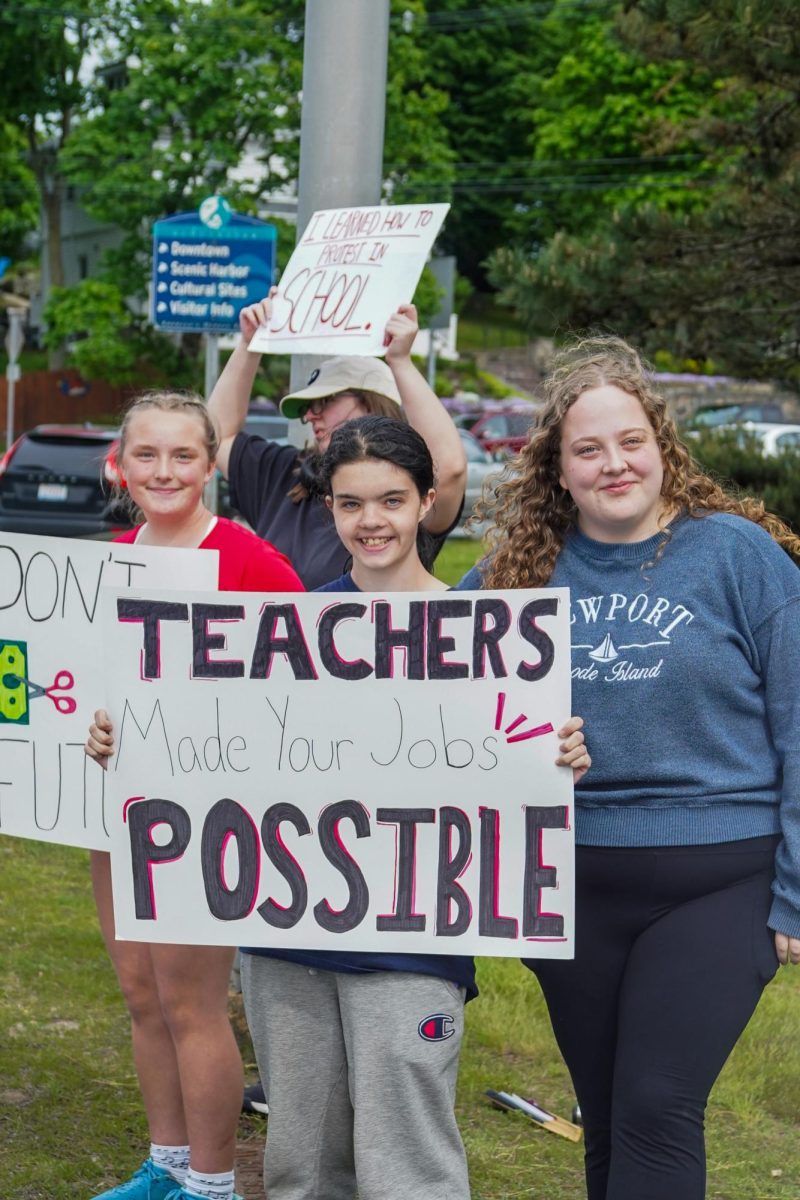 Cece Weagle, Lacey Barry, and Anita Rose Burns rally to support a level funded school budget