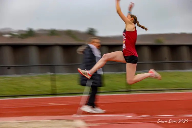 Hope Castellucci soars through the air during triple jump. Photo Courtesy of Dawn Enos

